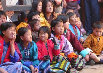 Children watching dance festival - bhutan