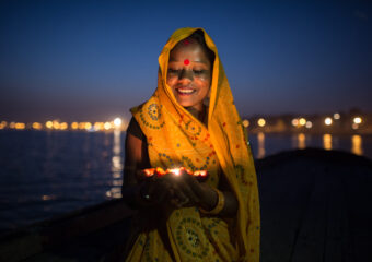 Woman devottee floating candles in sacred river Ganges - Ganga - Varanasi - North - India
